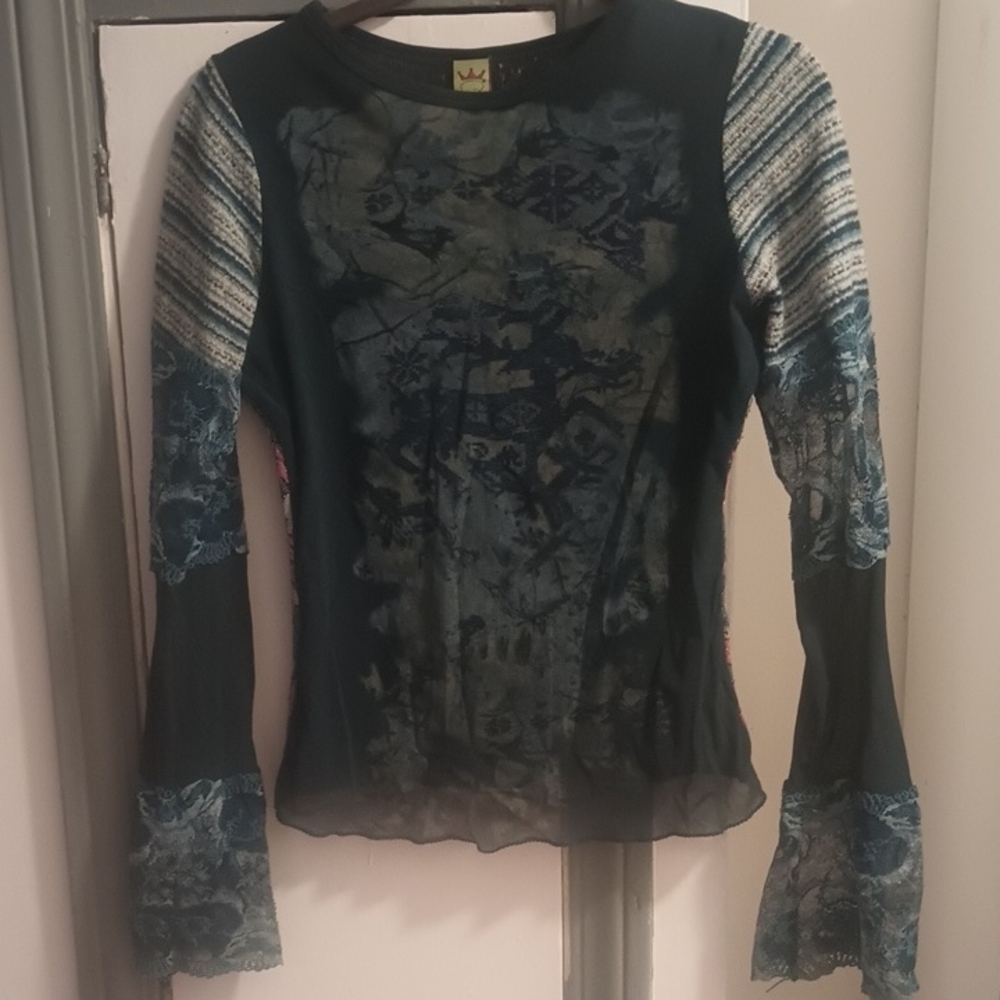 Blue long sleeve fitted top with crew neck and asymmetrical style features